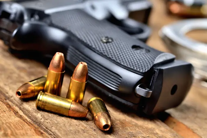 Image of a handgun and bullets.
